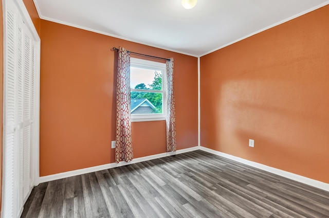 interior space with a closet, hardwood / wood-style floors, and crown molding