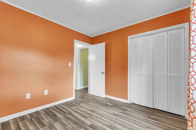 unfurnished bedroom featuring a closet, light wood-type flooring, and ornamental molding