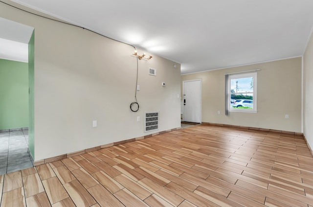 unfurnished room with ornamental molding