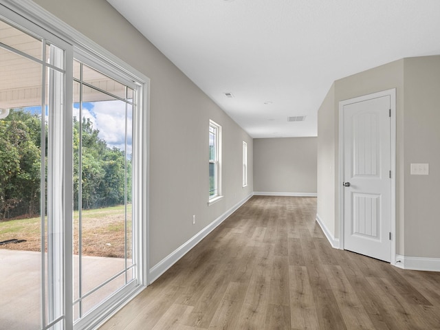 unfurnished room with light wood-type flooring