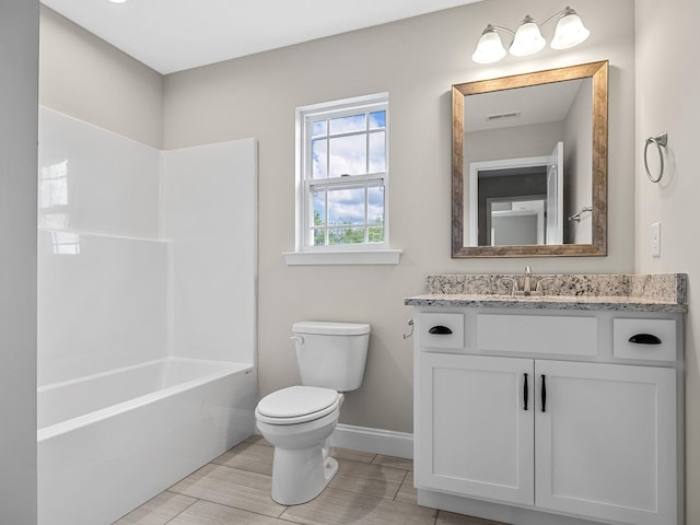 full bathroom featuring bathing tub / shower combination, vanity, and toilet