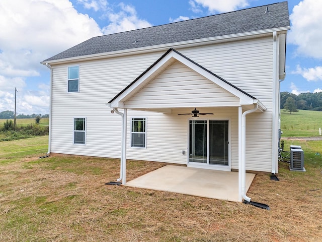 rear view of house with a lawn, cooling unit, ceiling fan, and a patio area