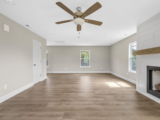 unfurnished living room featuring ceiling fan and hardwood / wood-style flooring