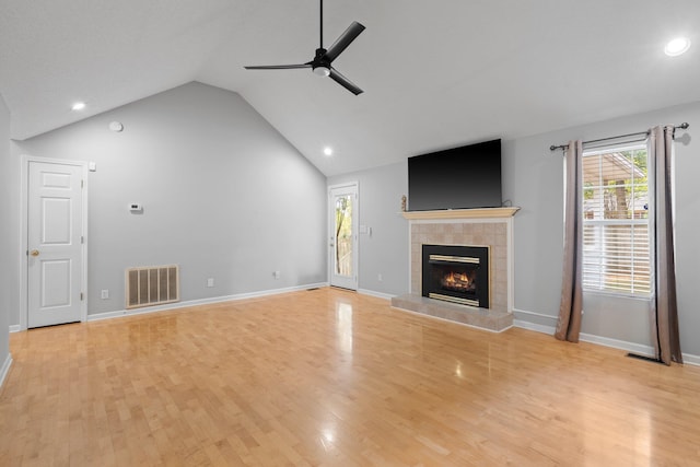 unfurnished living room featuring a fireplace, vaulted ceiling, ceiling fan, and light hardwood / wood-style flooring