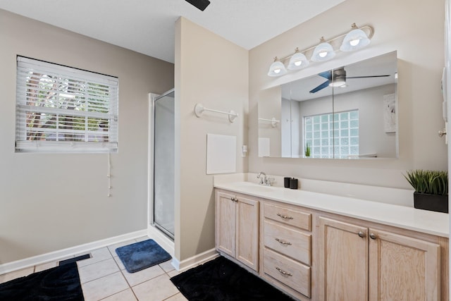 bathroom featuring ceiling fan, vanity, an enclosed shower, a textured ceiling, and tile patterned floors