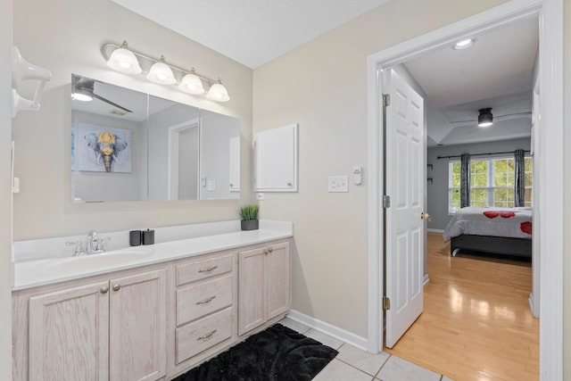 bathroom with wood-type flooring, ceiling fan, and vanity