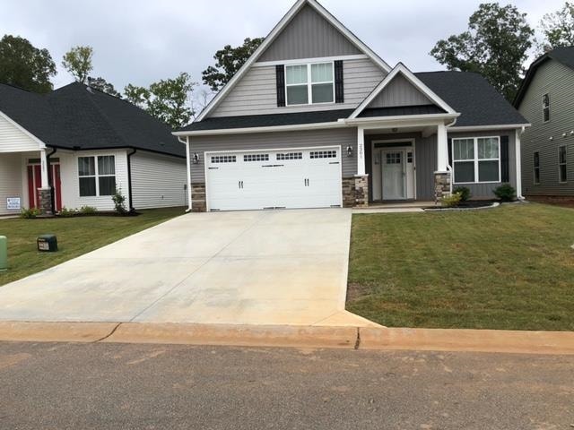 craftsman house featuring a garage and a front yard