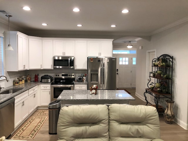 kitchen featuring white cabinetry, stone countertops, pendant lighting, stainless steel appliances, and sink