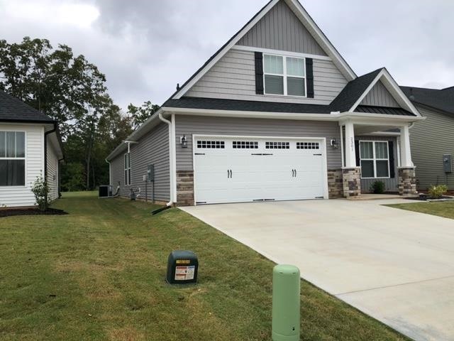 craftsman-style house with a front lawn and a garage