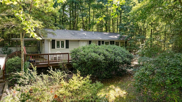 rear view of property featuring a wooden deck