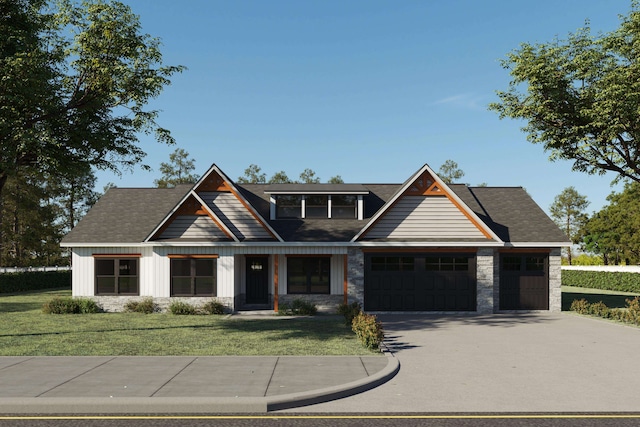 craftsman-style house featuring a front yard and a garage