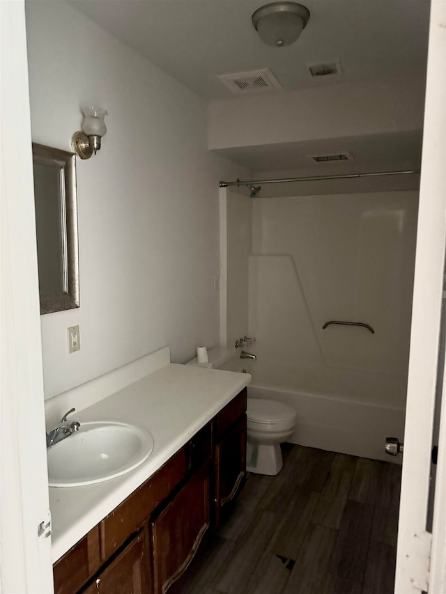 full bathroom featuring wood-type flooring, vanity, toilet, and shower / bathing tub combination