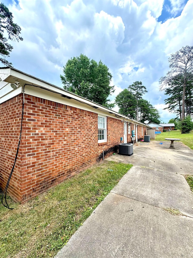 view of side of home featuring central air condition unit