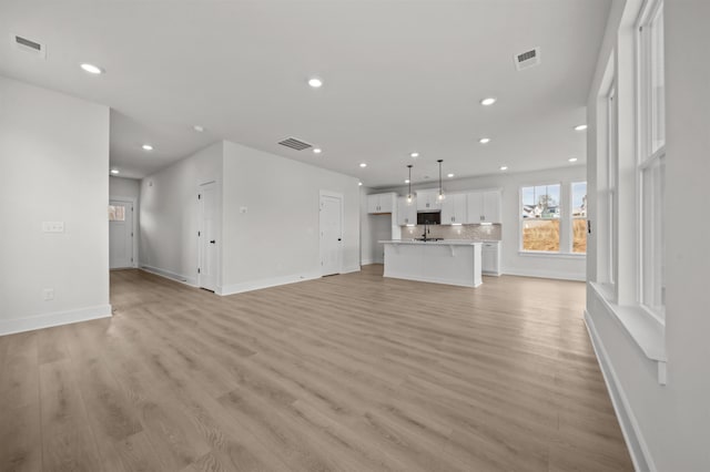 unfurnished living room with light hardwood / wood-style flooring