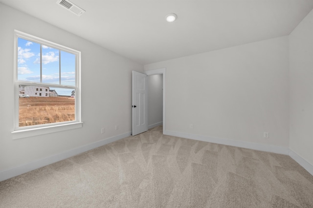 unfurnished room with light carpet