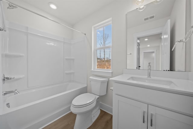 full bathroom with tub / shower combination, hardwood / wood-style flooring, toilet, and vanity