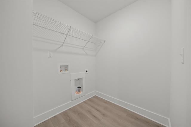 laundry room with hookup for a washing machine, hookup for an electric dryer, and light wood-type flooring