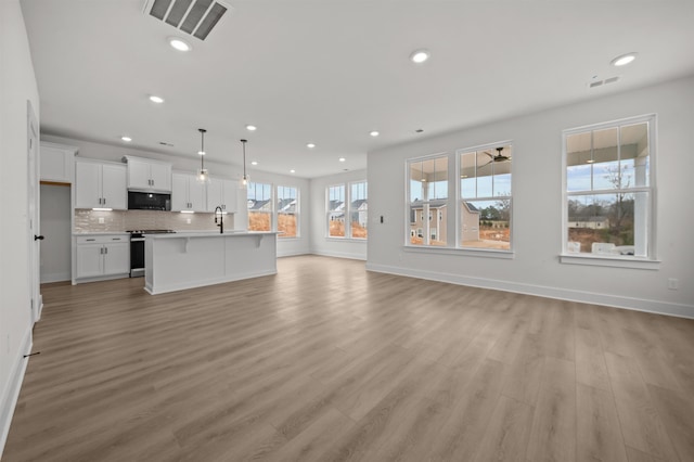 unfurnished living room with light wood-type flooring