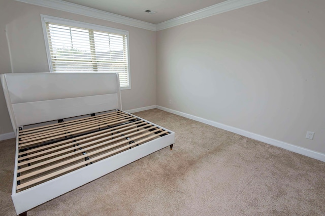 unfurnished bedroom with crown molding and light colored carpet