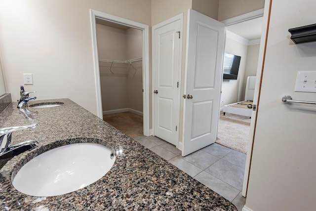 bathroom featuring vanity, crown molding, and tile patterned flooring