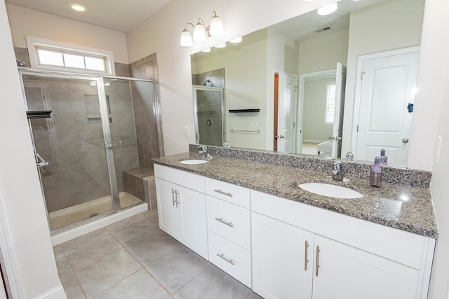 bathroom featuring a wealth of natural light, an enclosed shower, vanity, and tile patterned flooring