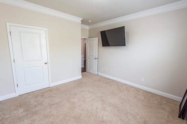 unfurnished bedroom featuring crown molding and light colored carpet