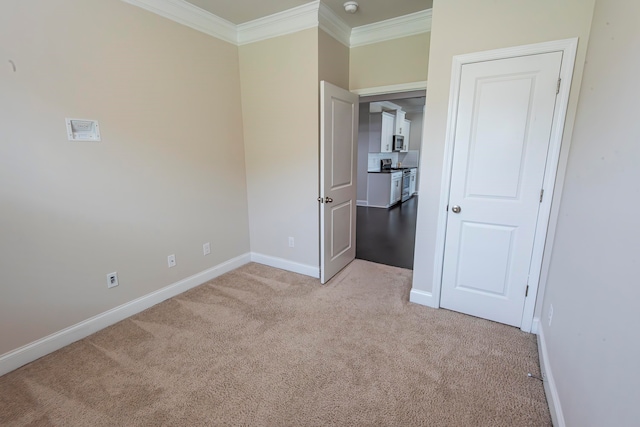 unfurnished bedroom with light colored carpet and crown molding