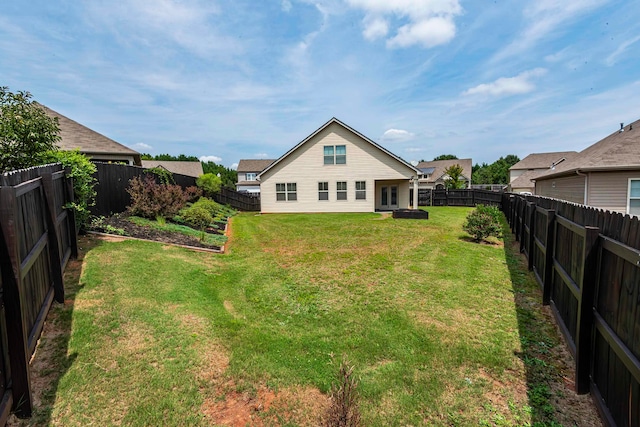 rear view of house with a yard