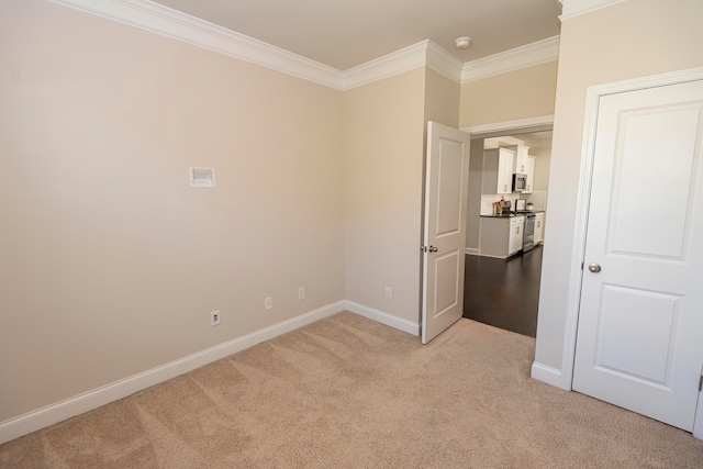 spare room with light carpet and crown molding