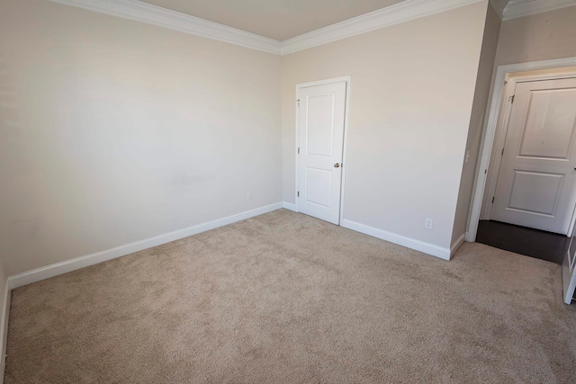 spare room featuring light carpet and ornamental molding