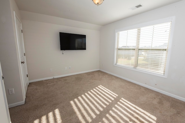 carpeted spare room with vaulted ceiling