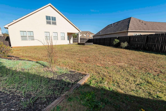 rear view of house featuring a yard