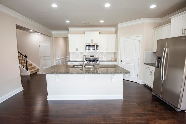 kitchen featuring sink, white cabinets, a center island with sink, and stainless steel appliances