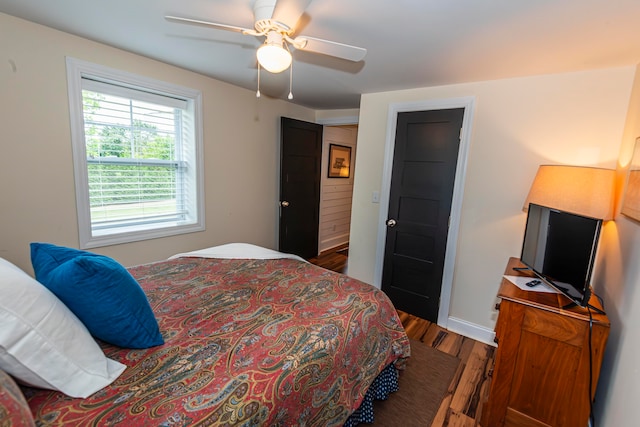 bedroom featuring ceiling fan and dark hardwood / wood-style floors