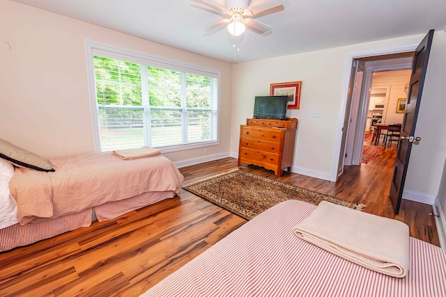 bedroom featuring ceiling fan and dark hardwood / wood-style flooring