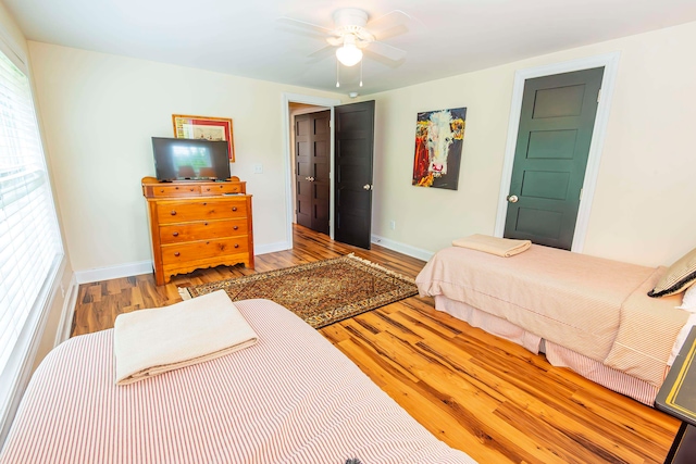 bedroom with ceiling fan and light hardwood / wood-style flooring