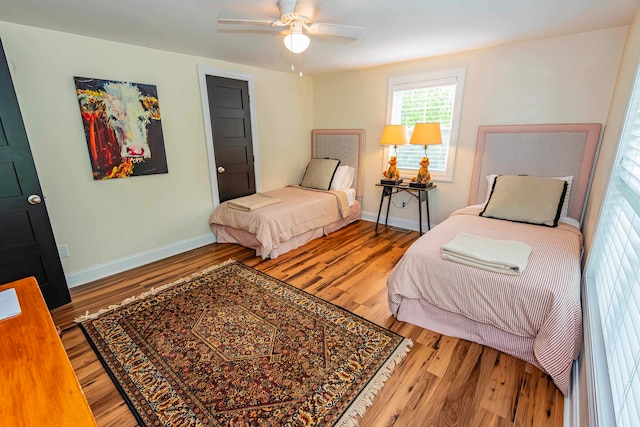 bedroom with wood-type flooring and ceiling fan