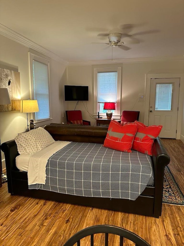 bedroom featuring crown molding, hardwood / wood-style floors, and ceiling fan