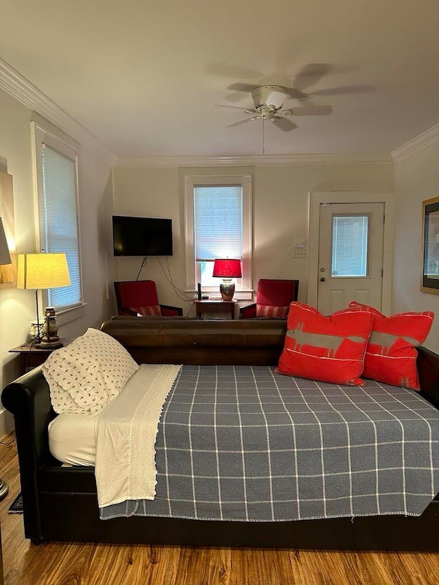 bedroom featuring ornamental molding, hardwood / wood-style floors, and ceiling fan