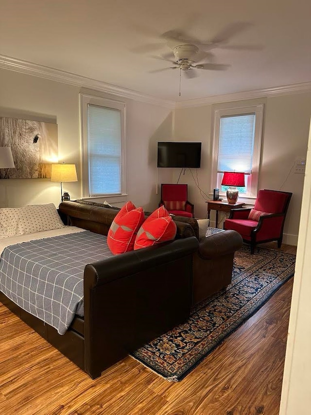 bedroom featuring ceiling fan, hardwood / wood-style floors, and crown molding