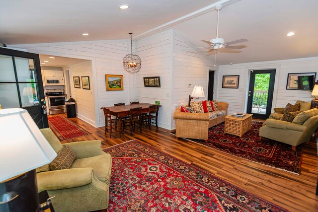 living room featuring lofted ceiling, ceiling fan, and hardwood / wood-style flooring