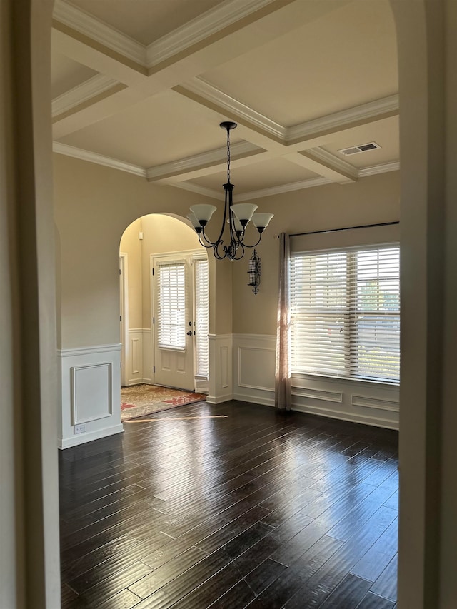 unfurnished dining area featuring ornamental molding, beamed ceiling, coffered ceiling, and dark hardwood / wood-style flooring