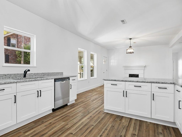 kitchen featuring dishwasher, hanging light fixtures, dark hardwood / wood-style flooring, and white cabinetry