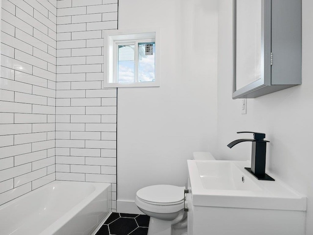 full bathroom featuring tiled shower / bath, vanity, tile patterned flooring, and toilet