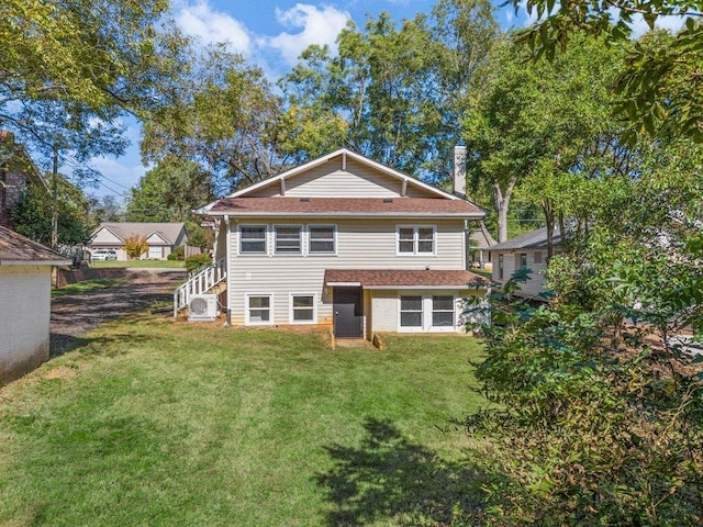 rear view of property with a yard