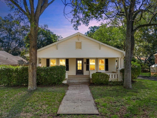 view of front of house featuring a yard and covered porch