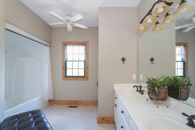 bathroom with shower / bath combo with shower curtain, tile patterned flooring, ceiling fan, and vanity