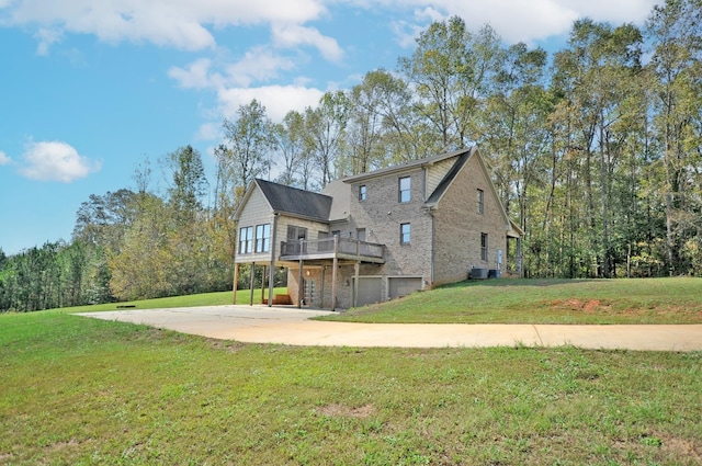 back of property featuring a wooden deck and a lawn