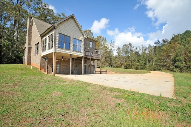 back of property featuring a lawn and a carport