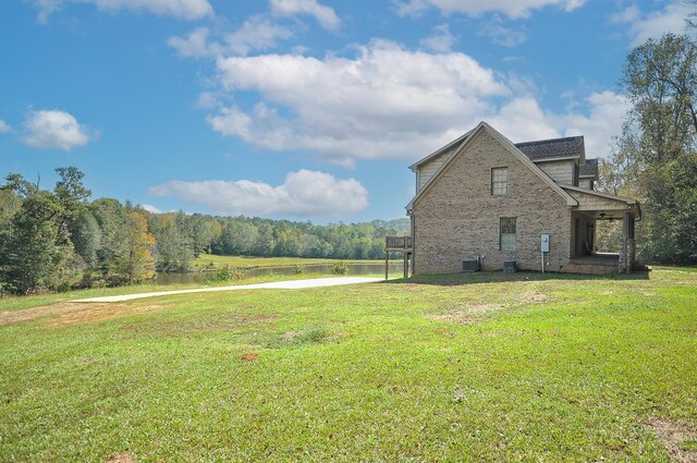 view of home's exterior with central air condition unit and a yard